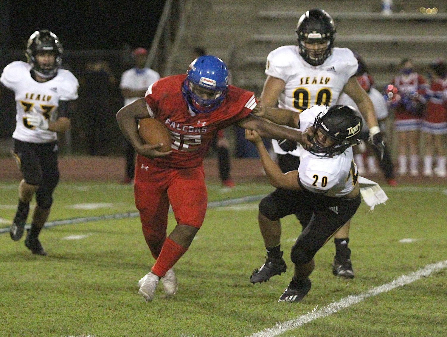 Falcon senior fullback Matthew Green delivers a stiff arm to Sealy senior linebacker Stevie Alvarez in the second half of the first game within District 12-4A-D2 this season in Brookshire on Oct. 9, 2020. The visiting Tigers won, 43-8.
